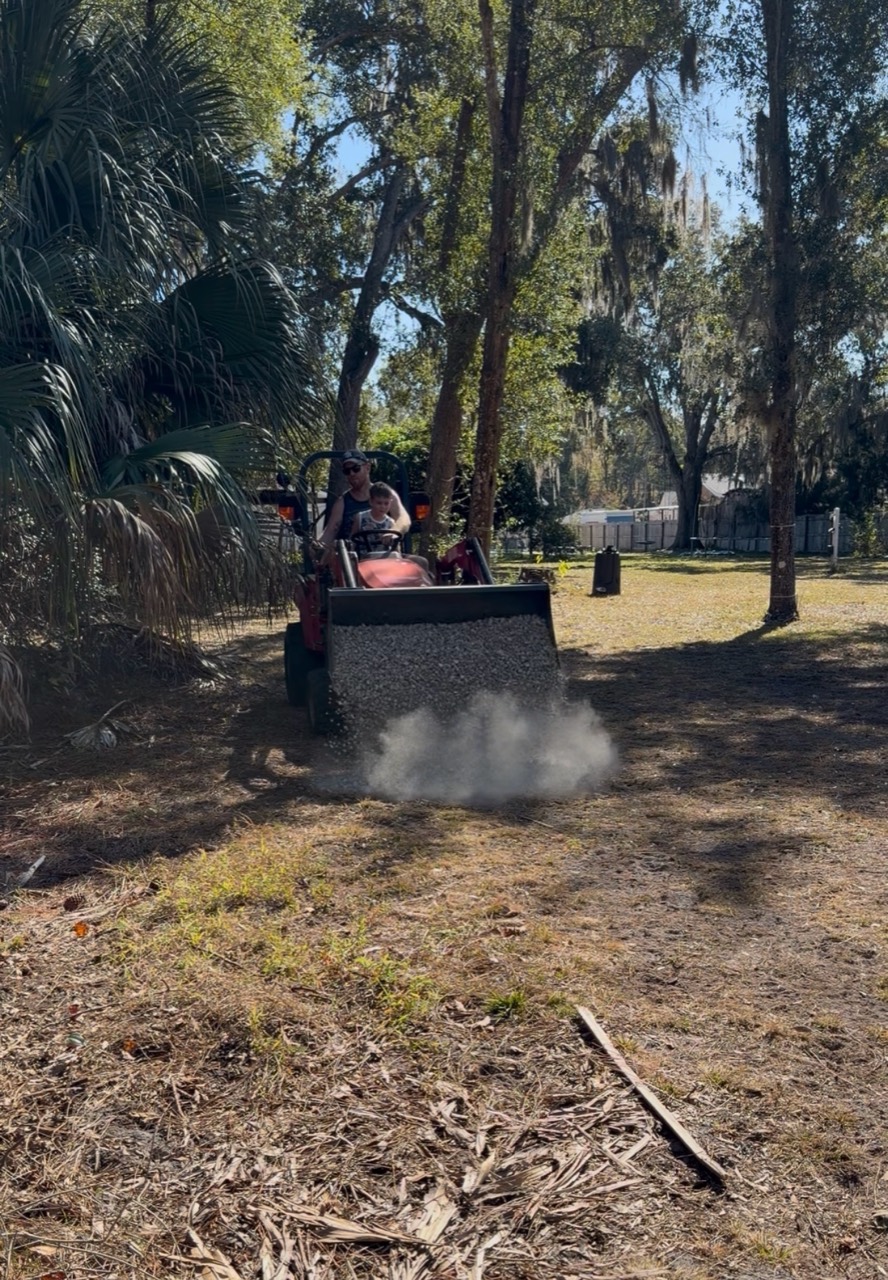 Little Tractor Co compact tractor spreading gravel during a residential property project
